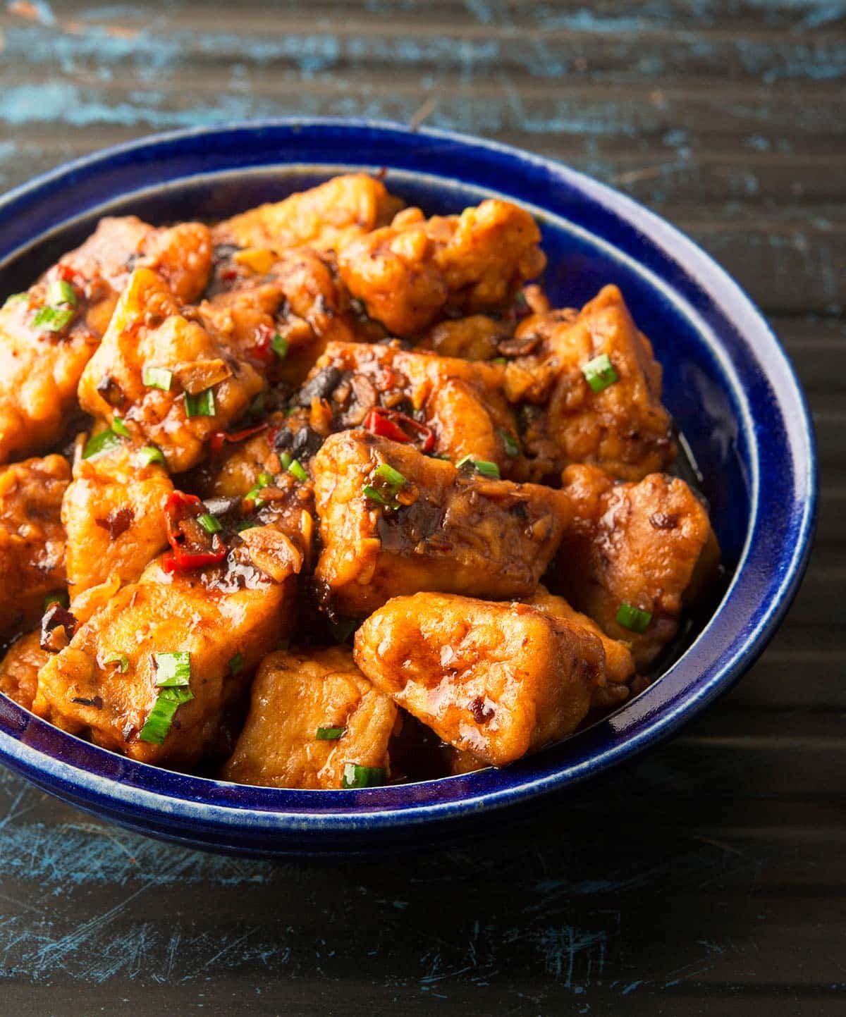 A bowl of fish stir fry with halibut. 