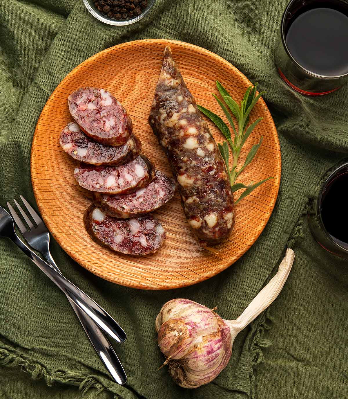 Overhead view of venison salami sliced on a plate. 