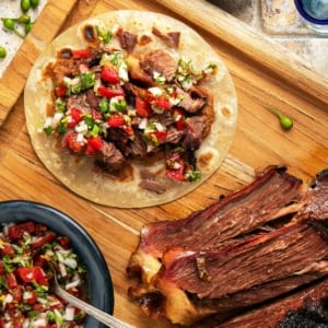 A brisket taco on a cutting board.