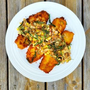 A plate of fried walleye with chanterelle sauce.