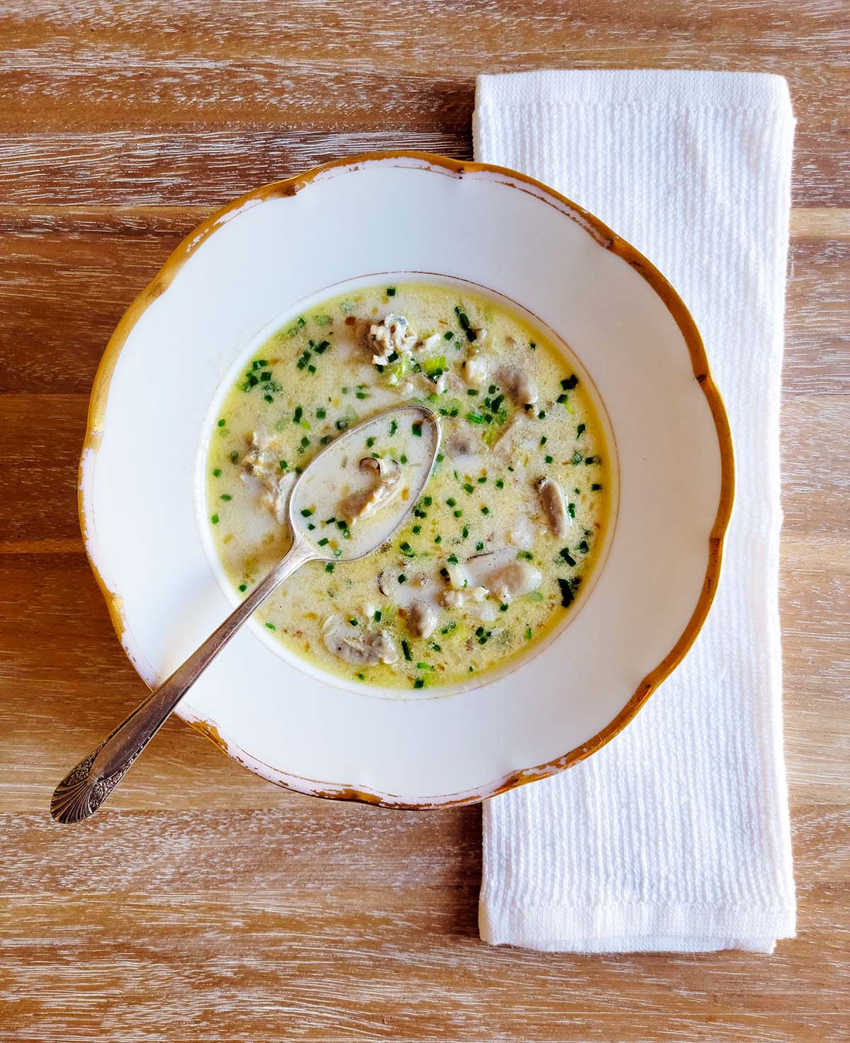 A bowl of oyster stew on a table. 