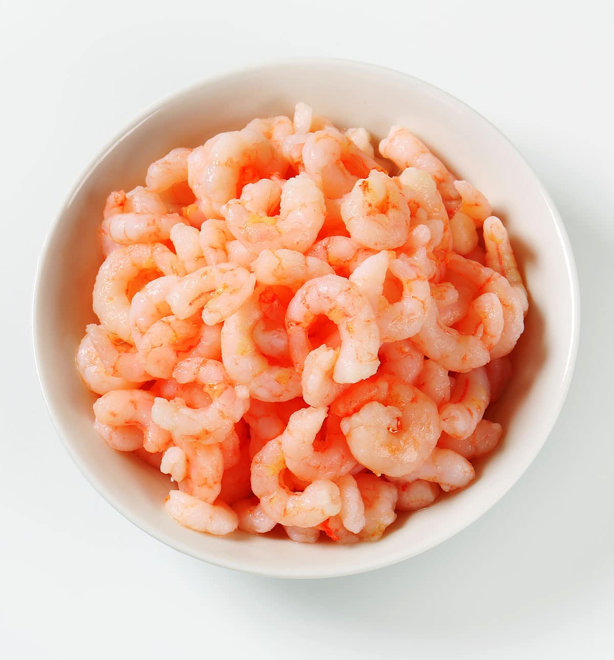 Shelled and cooked pink salad shrimp in a bowl. 