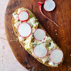 Whitefish salad on rye bread with radishes.