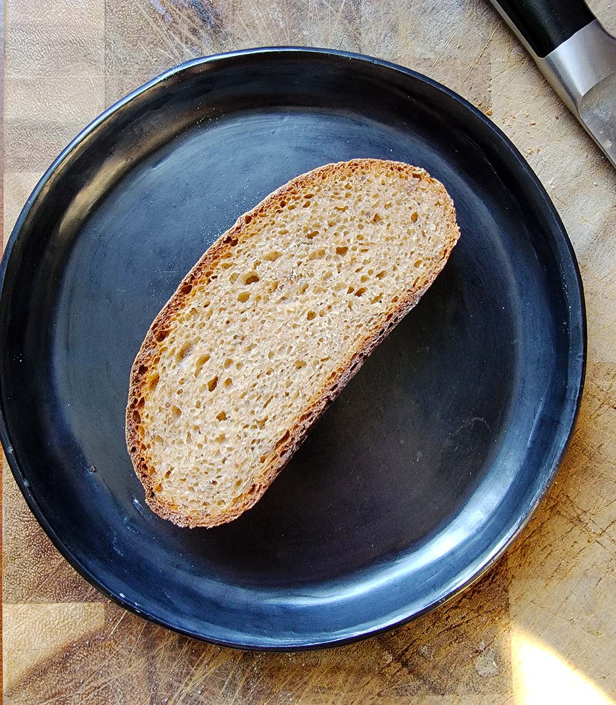 A slice of rye sourdough, showing the crumb.