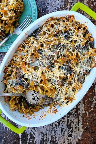 A mushroom casserole on a table with a serving removed.