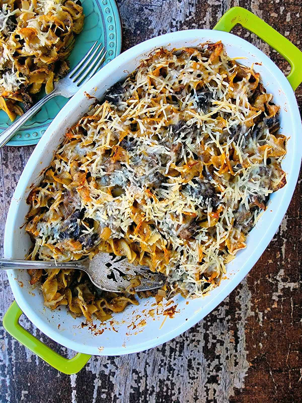 A mushroom casserole on a table with a serving removed. 