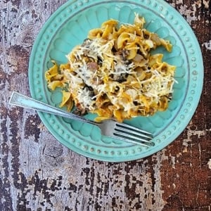 A serving of mushroom casserole on a blue plate.