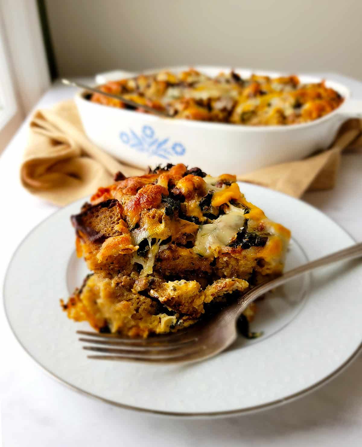 A portion of sausage strata on a plate. 