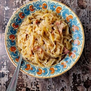 A bowl of German sauerkraut with bacon and applesauce, a great side dish.