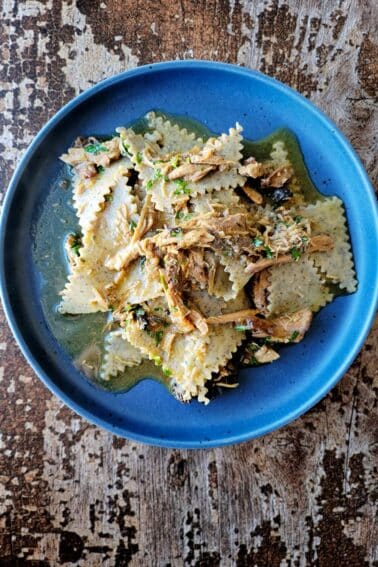 A plate of buckwheat pasta, blecs, with a chicken and onions sauce.