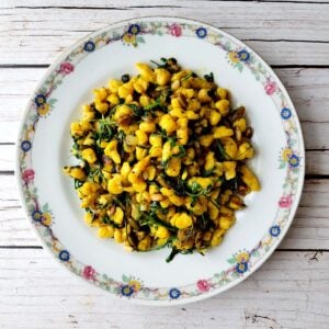 A plate of squash spaetzle with greens.