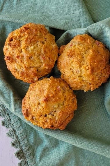 Close up of rhubarb muffins on a tea towel.