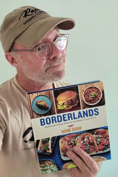 Hank Shaw holding a copy of his new book Borderlands.