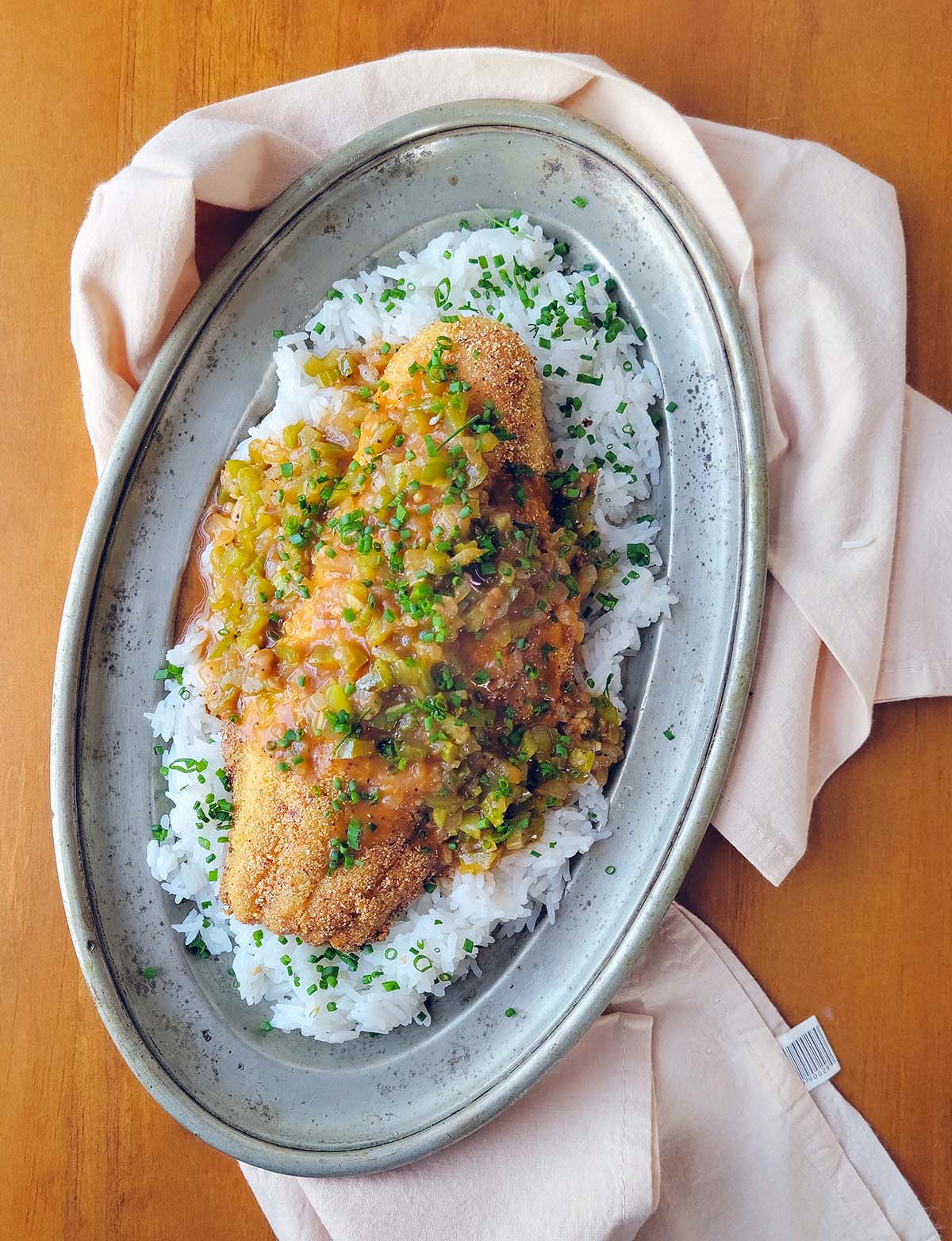 A platter of catfish etouffee over white rice.